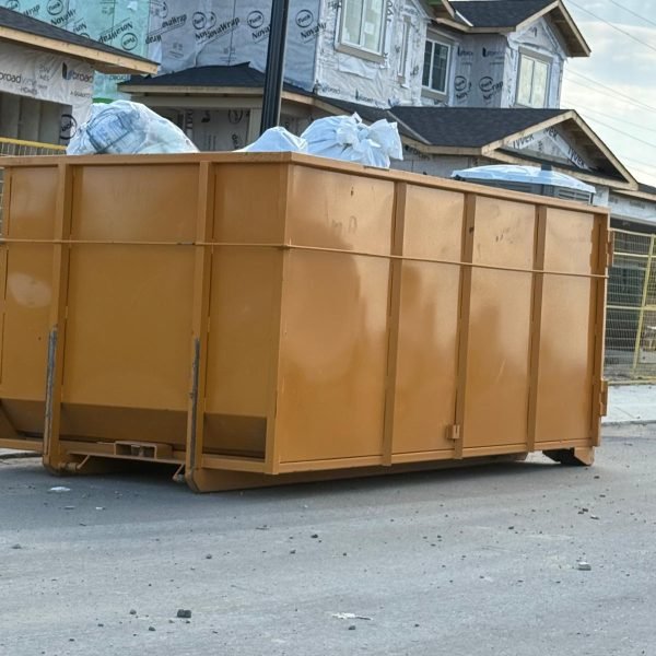 Equi-Waste Truck Unloading Yellow Dumpster Bins at Residential Site